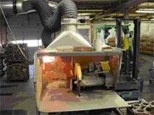Cutoff saw with ducted dust collector in industrial setting
